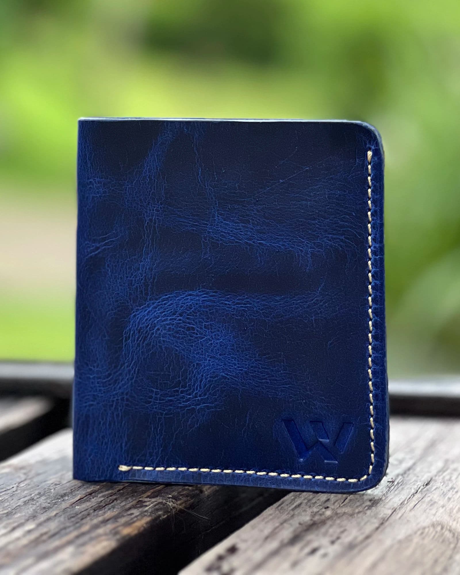 Blue leather card holder for men with cream stitching and embossed W logo by Wrenza