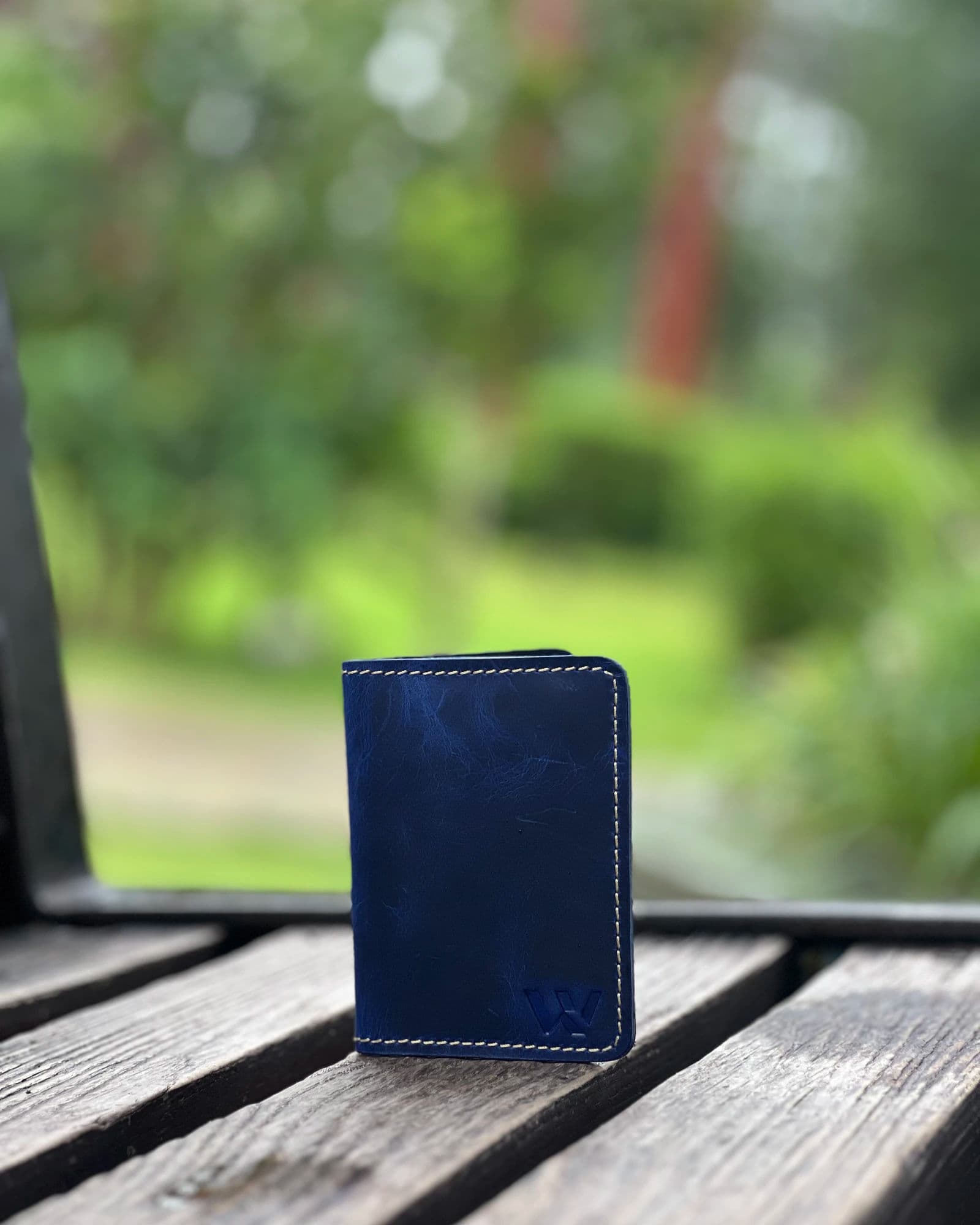 Blue compact leather card holder for men with cream stitching and embossed W logo by Wrenza